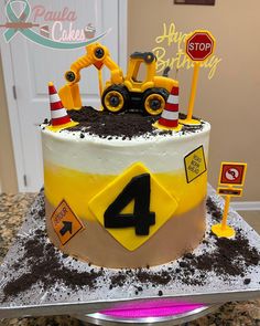 a birthday cake with construction themed frosting on it's top and the number four