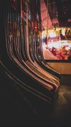 rows of skis are lined up in front of a window with the city lights behind them