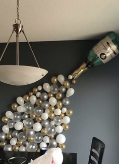 a room with balloons and wine bottles hanging from the ceiling