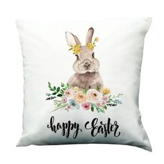 a white pillow with the words happy easter on it and a bunny wearing a flower crown