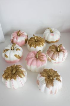 white and pink pumpkins with gold glitter on them