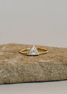 Known as the strongest unit, the triangle represents connection, harmony, creativity, and wisdom. A single cubic zirconia is set into this beloved shape, creating a statement piece to stack or wear alone. Handcrafted by artisans in the US, this 14kt gold vermeil ring makes a great addition to any stack. A touch of glamour and a symbol of strength. Material: 14kt gold vermeil (sterling silver 925 base) Dimensions: Band width approx 1mm; Triangle setting approx 7mm Meet the Brand: JaxKelly is led Symbols Of Strength, The Triangle, 14kt Gold, Gold Vermeil, Silver 925, Gold Ring, Cubic Zirconia, Gold Rings, How Are You Feeling