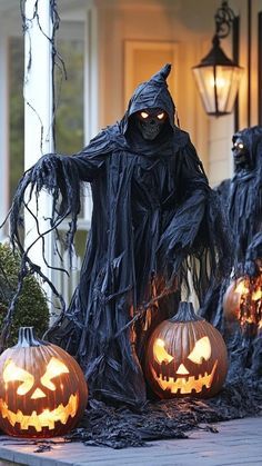 halloween decorations with carved pumpkins and ghost faces