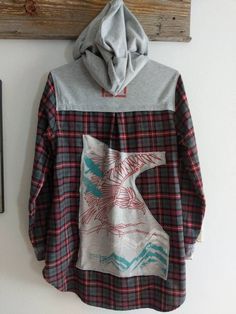 Nice long hooded flannel that would be perfect to wear with leggings. I added a  patch on the back from a t-shirt. I also hand painted a design on the back as well as on a denim patch. Bleached flannel patches added to the cuffs.  Measurements Chest: 20 inches Sleeves: 24 inches Shoulder to hem: 30 inches Be sure to check the size and measurements. All sales are final. This is a previously owned garment. I search out clothing that looks to be in great condition. I will replace buttons and make repairs as needed. Many of my designs are more rugged and a few rips add to what I want in a look. All clothing should be in a condition to be worn for many years. I wash everything once I bring it home and then I do my creative thing. Buying clothing in this manner saves water and energy. Hooded Plaid Cotton Flannel Shirt, Patchwork Long Sleeve Flannel Shirt For Fall, Bleached Flannel, Hooded Flannel, Mens Flannel Shirt, Bleach Dye, Denim Patches, Womens Tunics, Layering Pieces