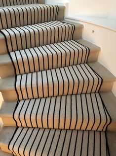 a set of stairs with black and white striped carpet