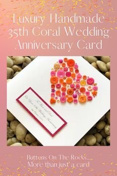 an anniversary card with buttons on the rocks and a heart shaped piece of paper that says, luxury handmade 35th coral wedding anniversary card