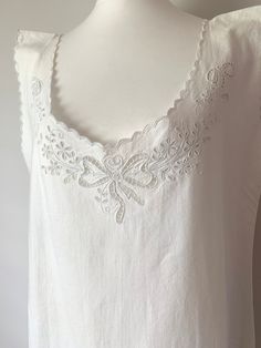 ANTIQUE French Pure Organic Linen Slip with Broderie Anglaise✨ Stunning French Victorian slip in heavyweight, antique organic Linen. Spectacular quality fabric, satisfyingly heavy and non seethrough - would also  make this piece ideal worn as dress in summer. Expertly handmade, this sleeveless slip features extensive, elegant broderie anglaise on the front bodice in a bow and floral motif. Length approx. mid-calf, traditional scalloped trim on front, back and armholes. In rare perfect condition! Cotton Sleeveless Camisole With Floral Embroidery, White Floral Embroidery Camisole Tank Top, White Floral Embroidered Camisole Tank Top, Elegant Sleeveless Tops With Scalloped Edges, Sleeveless Broderie Anglaise Tops For Daywear, Embroidered Sleeveless Camisole, Daywear Ruffled Sleeveless Camisole, Ruffled Camisole For Daywear, Ruffled Sleeveless Camisole For Daywear