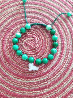 **  This Bracelet are made of 8 mm       Green Jade beads and 15*10 Hand       carved   beautiful Jade Tiger. Hand       made green Color string and a        adjustable. **  The year of the Tiger (2022,2010.       1998.1986.1974.1962.1950.1938) **  Men Born in the Tiger year are        adventurous spirits. They are        positive and have high beauty        standards. ** Women Born in Tiger year are       mesmerizing. They love the freedom        to express themselves, through,         fashion and work. They are lovely         and friendly. ** It's a good gift for everyone. Adjustable Jade Beaded Bracelets With 8mm Beads, Green Hand-strung Braided Bracelet With Round Beads, Green Hand-strung Braided Bracelets, Green Braided Bracelets With Sliding Knot And Round Beads, Green Friendship Bracelets With Sliding Knot And Round Beads, Tiger Bracelet, Year Of The Tiger 2022, Jade Bead Bracelet, Tiger Year