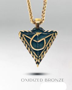 a necklace with the letter c on it and an image of a triangle shaped pendant