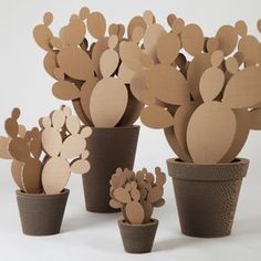 paper cut out cactus in pots on white background