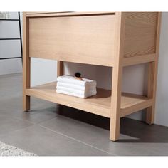 a wooden shelf with folded towels on it