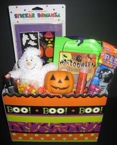 a halloween gift box filled with candy, candies and a stuffed animal in it