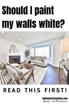 a living room filled with furniture and a fire place in front of a window that reads should i paint my walls white? read this first