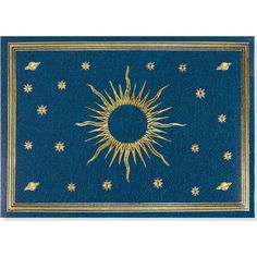 a blue and gold rug with an image of the sun on it's center