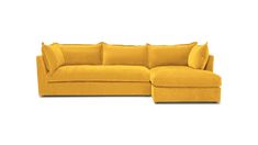 a yellow sectional couch with pillows on the top and bottom, sitting in front of a white background