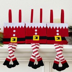 three christmas stockings hanging from a mantel