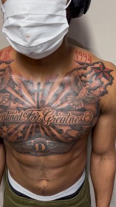 a man wearing a face mask with tattoos on his chest