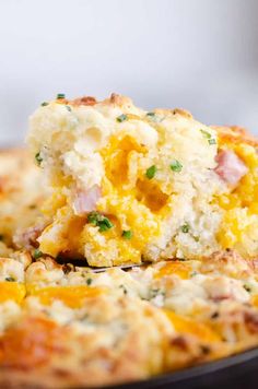 a close up of a piece of food on a plate with broccoli and cheese