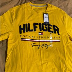 New W/ Tags Tommy Hilfiger Status Tee Sz. Medium Yellow Tommy Hilfiger Cotton Graphic Print Shirt, Tommy Hilfiger Cotton Shirt With Graphic Print, Tommy Hilfiger Graphic Print Cotton Shirt, Tommy Hilfiger Graphic Print Short Sleeve Shirt, Casual Yellow Shirt With Logo Print, Tommy Hilfiger Graphic Tee For Spring, Yellow Tommy Hilfiger Cotton Top, Yellow Cotton Tommy Hilfiger Top, Tommy Hilfiger Yellow Cotton Tops