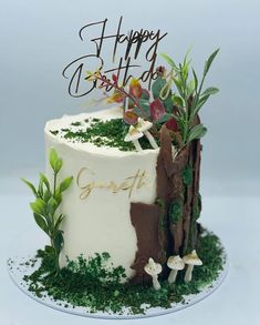 a birthday cake decorated with moss and flowers