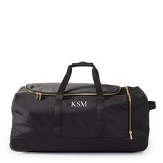 Elegantly functional and conveniently configured, the Terminal 1 Rolling Duffle is crafted from high quality recycled nylon accented by gold hardware and vegan leather details. Sized just right for longer getaways, it has a spacious main compartment and a side compartment great for keeping shoes or smaller items separate. Features two top handles for carrying and a telescoping handle for easy rolling. Add a monogram to put a personal touch on your travel.    28"w x 16"d x 12.5"h  Recycled polyes Functional On-the-go Luggage With Leather Trim, Functional Travel Bag With Leather Trim For Business Trips, Luxury Nylon Travel Bag, Functional Duffle Bag For Business Trips With Leather Trim, Nylon Travel Bag With Leather Trim, Luxury Nylon Travel Duffle Bag, Luxury Nylon Duffle Bag For Travel, Functional Bags With Leather Trim For Trips, Functional Bag With Leather Trim For Trip