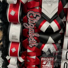 red and white ribbons are stacked on top of each other in the shape of letters