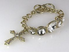 This is an incredible Christian Cross bracelet that features a stunning Cross charm with sparkling CZ stones throughout. The link chain have 2 size rings and 5 huge incredible CZ Stones. Very good quality! Comes in a beautiful satin lined gift box with a satin ribbon and bow, no wrapping required. We have large quantities available for bulk purchasing, please Ebay message us if you need a quantity larger than what is shown on hand. Bling Rhinestones, Rhinestone Fashion, Cuff Watch, Christian Cross, Cross Bracelet, Cross Charms, Bracelets And Charms, Cz Stone, Satin Ribbon