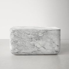 a white marble block sitting on top of a table