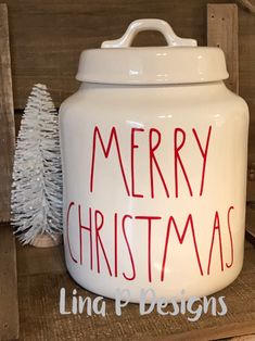 a white christmas cookie jar sitting on top of a wooden shelf