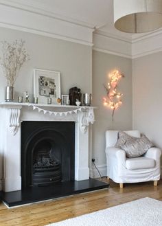 a living room filled with furniture and a fire place in the middle of the room