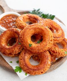 onion rings on a plate with dipping sauce