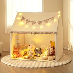 a white tent with teddy bears and lights in it