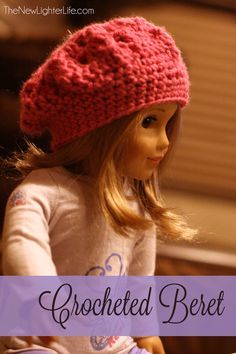 a doll sitting on top of a table wearing a pink knitted hat with the words crocheted beret written below it