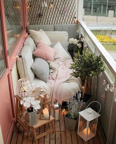 the balcony is decorated with flowers, candles and other things to decorate for an outdoor party