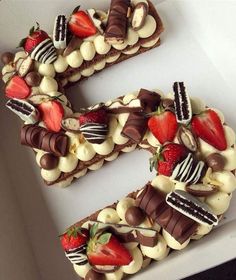 a number shaped cake with chocolate and strawberries on top