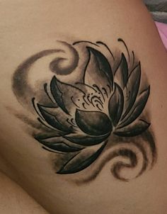 a woman's stomach with a flower tattoo on it