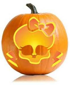 an orange pumpkin with a skull and bow on it's head, cut out into the shape of a cat