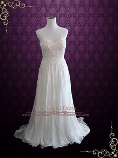 a white wedding dress is on display in front of a purple background with gold accents