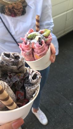 two bowls filled with different types of ice cream and toppings on top of each other