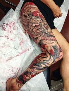 a man with a dragon tattoo on his arm