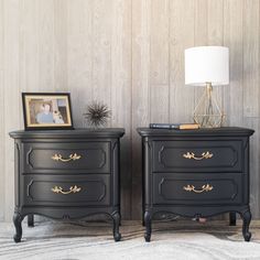 two black nightstands side by side with pictures on them