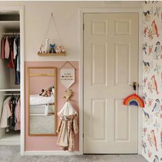 a child's bedroom with pink walls and white closet doors