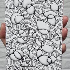 a person holding up a phone case with an intricate design on it