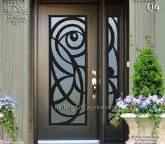 the front door is decorated with flowers and potted plants on either side, along with an ornamental glass panel