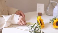 the man is arranging flowers on the table