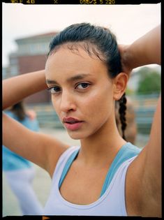 a woman with her hands on her head