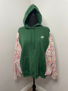 green floral hoodie rework using upcycled/thrifted materials SLEEVES ARE 3/4 LENGTH, THEY ARE NOT FULL LENGTH SLEEVES! The floral material is also very lightweight, making it perfect for spring. Please note before purchasing :) Pit to pit: 31" Length: 23" Fits S-L (the body will fit up to a 2XL but the sleeves only fit up to a large WASHING INSTRUCTIONS: for color preservation, please wash in cold water. Hang to dry! Vintage Hooded Hoodie For Spring, Green Patchwork Sweatshirt For Streetwear, Vintage Green Hooded Hoodie, Vintage Long Sleeve Hoodie For Spring, Green Sweatshirt For Spring Streetwear, Green Spring Sweatshirt For Streetwear, Vintage Green Long Sleeve Hoodie, Green Patchwork Hoodie For Streetwear, Green Cotton Patchwork Hoodie