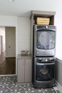 a washer and dryer stacked on top of each other in a laundry room