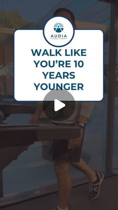 a man walking down a sidewalk next to a glass wall with the words walk like you're 10 years younger