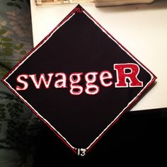 a black and red sign with the word swagger r on it's side